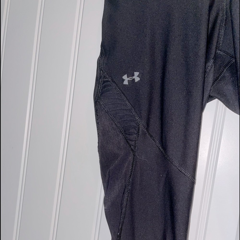 Black Under Armor leggings, mesh on the lower leg.